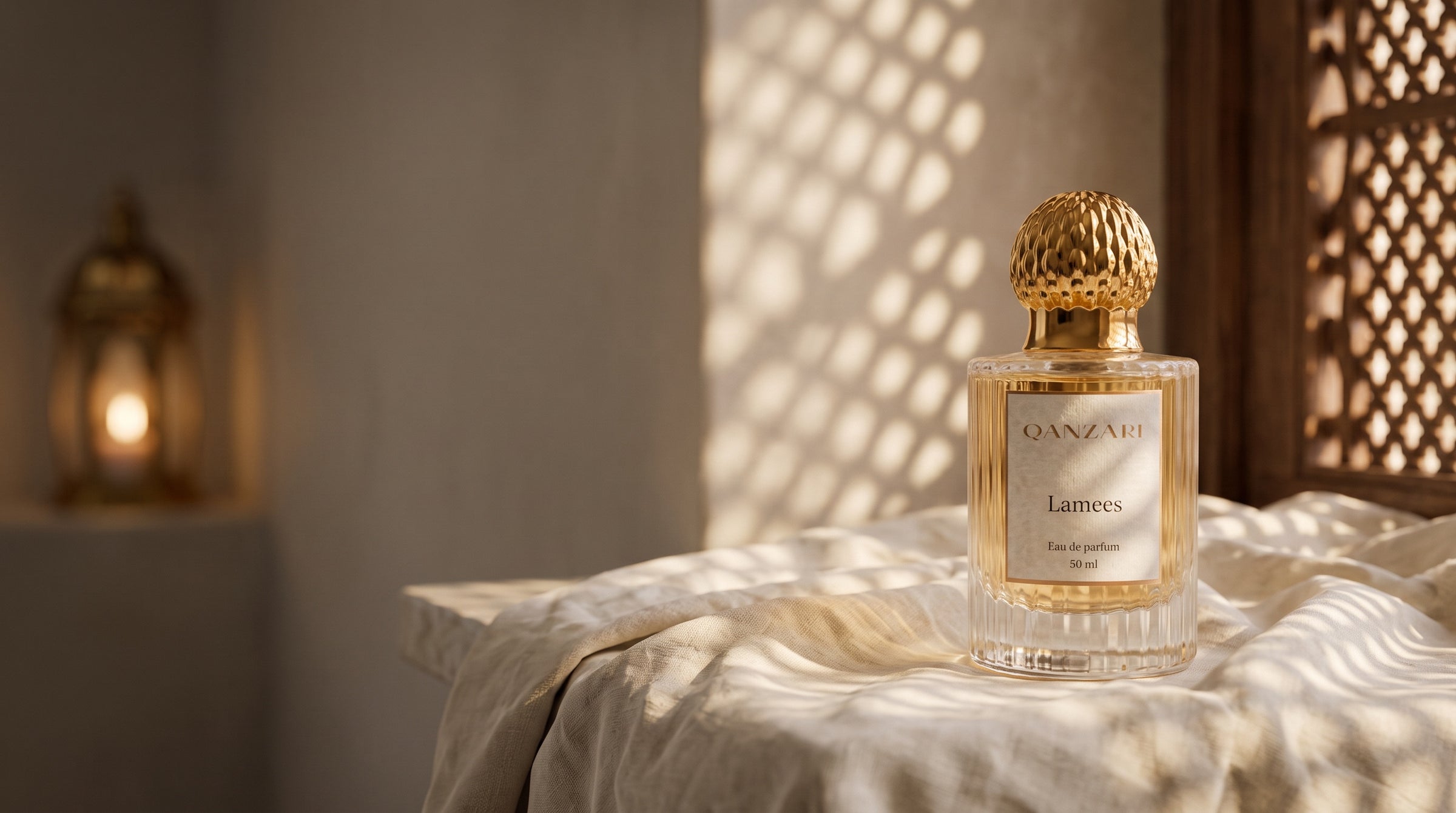 Qanzari Lamees eau de parfum on cream linen under mashrabiya lattice light