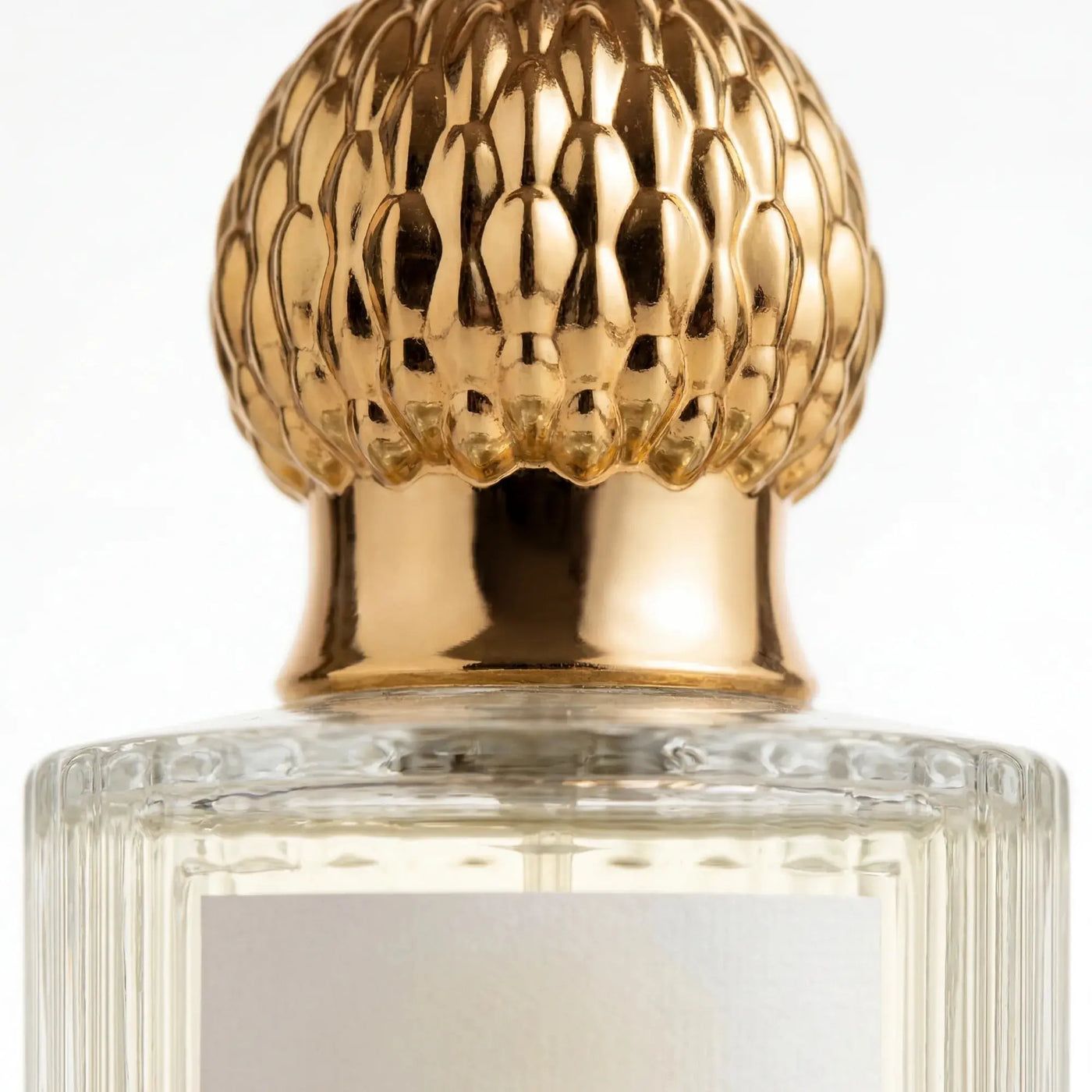 Close detail of the Qanzari Jawaher ornate domed gold cap against warm shadow
